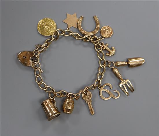 A 9ct gold charm bracelet with padlock clasp and 11 charms, gross 18.2 grams.